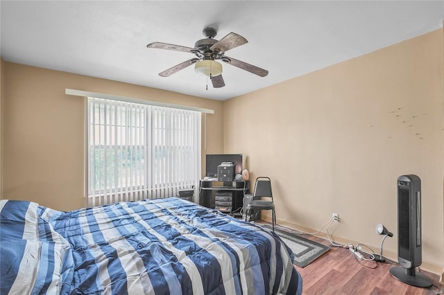 bedroom with wood-type flooring and ceiling fan