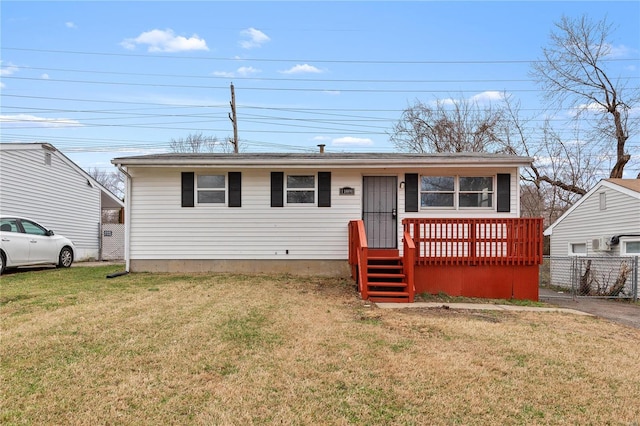 view of front of property with a wooden deck and a front lawn