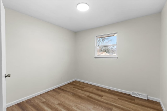 empty room with hardwood / wood-style flooring