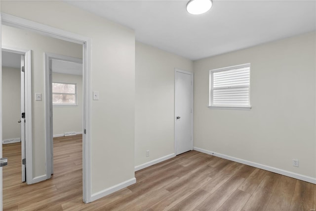 unfurnished bedroom with light hardwood / wood-style floors and a closet