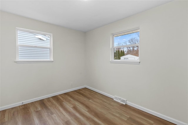 empty room with light hardwood / wood-style floors