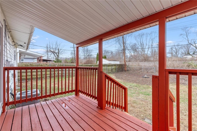 wooden terrace featuring a lawn