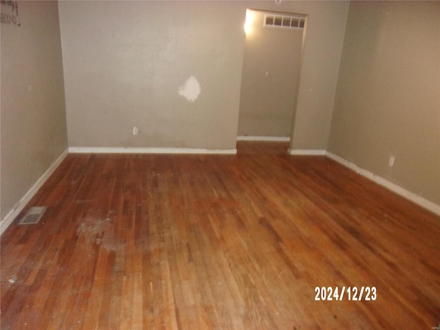 spare room featuring dark hardwood / wood-style floors