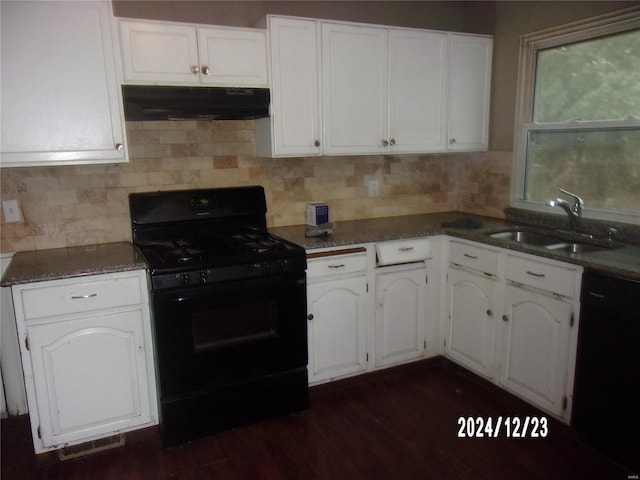 kitchen featuring decorative backsplash, white cabinetry, sink, and black appliances