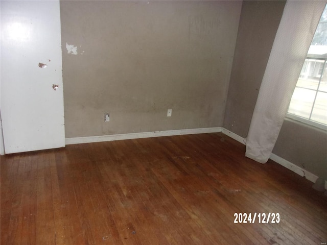 spare room featuring dark wood-type flooring