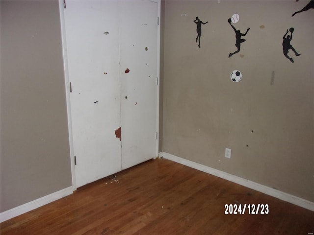 unfurnished room with hardwood / wood-style floors