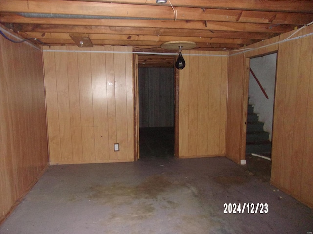 basement featuring wooden walls