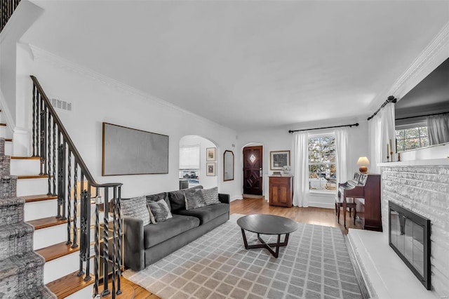 living room with light hardwood / wood-style flooring and ornamental molding