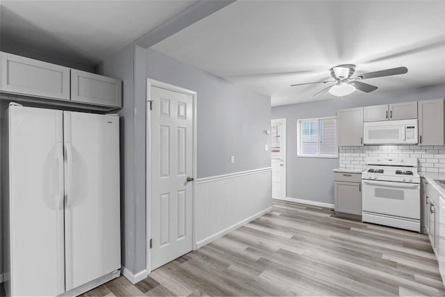 kitchen with ceiling fan, white appliances, light hardwood / wood-style floors, and decorative backsplash