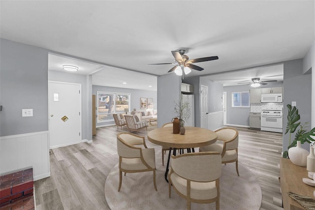 dining space featuring ceiling fan and light hardwood / wood-style flooring