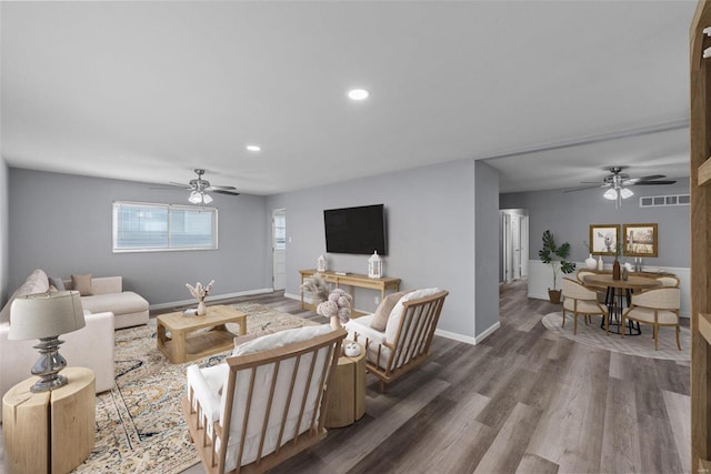 living room featuring ceiling fan and dark hardwood / wood-style floors