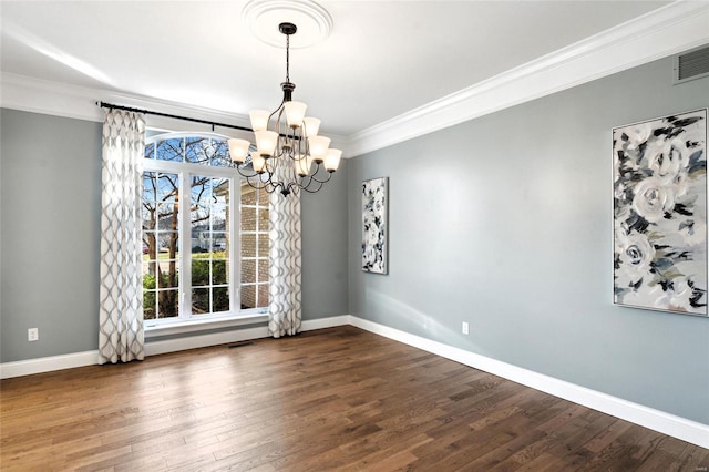 unfurnished dining area with dark hardwood / wood-style flooring, ornamental molding, and a chandelier