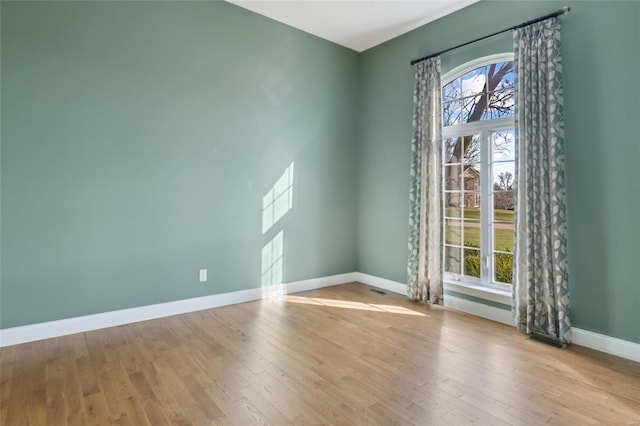 empty room with light hardwood / wood-style floors