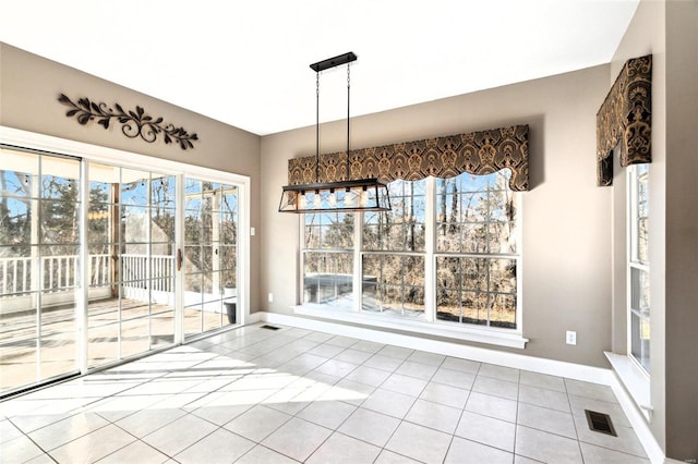 unfurnished dining area with tile patterned floors