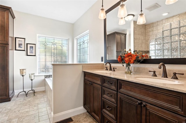 bathroom with vanity and tiled bath