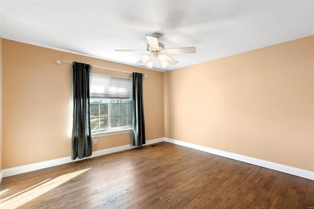 spare room with hardwood / wood-style floors and ceiling fan