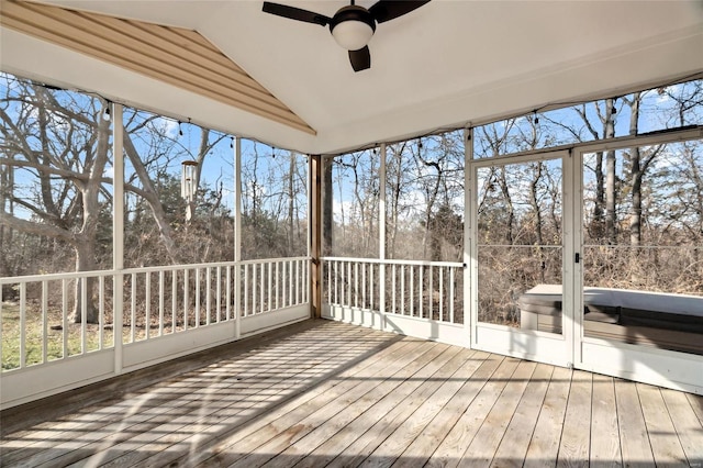 unfurnished sunroom featuring ceiling fan and lofted ceiling