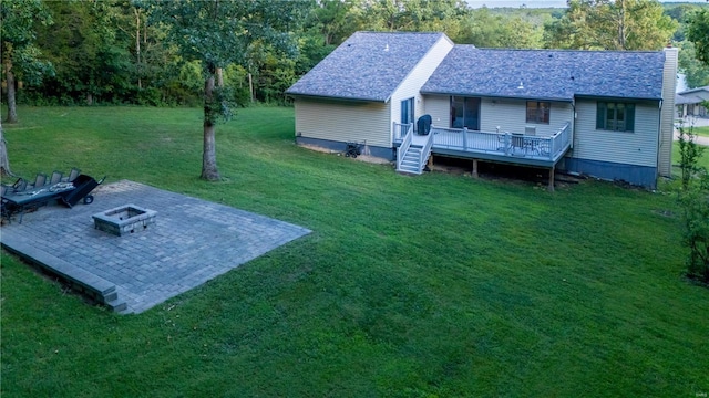 view of yard with a deck, a patio, and an outdoor fire pit