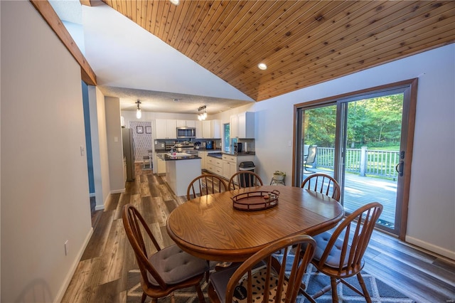 dining space featuring hardwood / wood-style floors, wood ceiling, and high vaulted ceiling