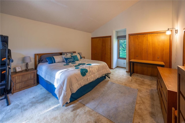 bedroom with lofted ceiling and light carpet