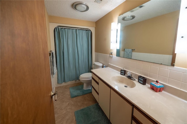 full bathroom featuring vanity, tile patterned floors, shower / bath combination with curtain, and a textured ceiling