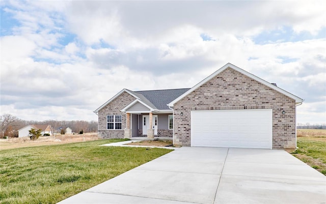 view of front of home with a front yard and a garage