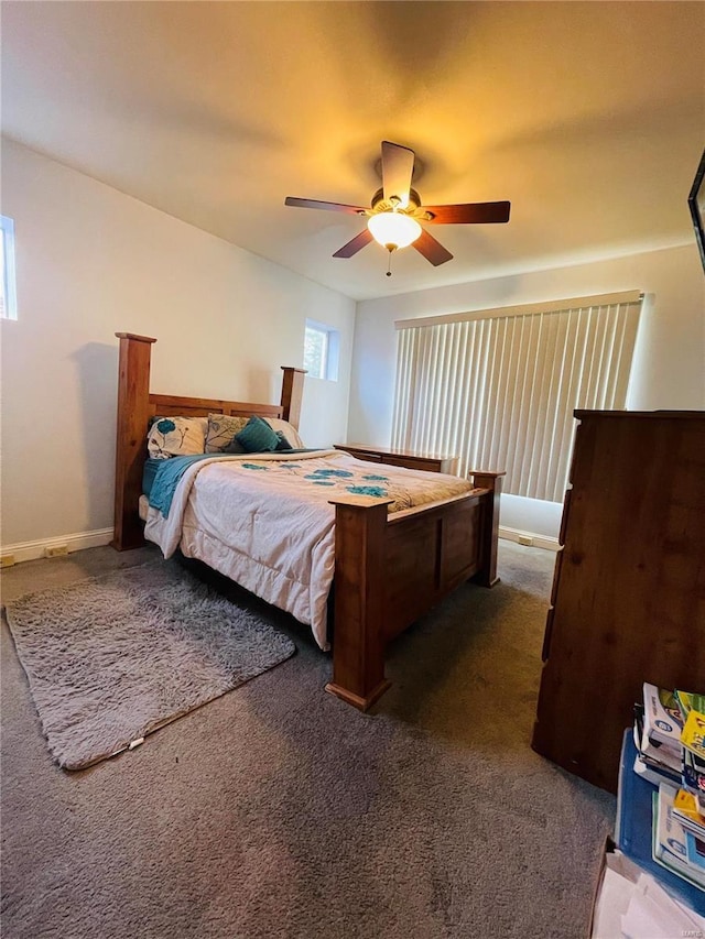 bedroom with ceiling fan and dark colored carpet