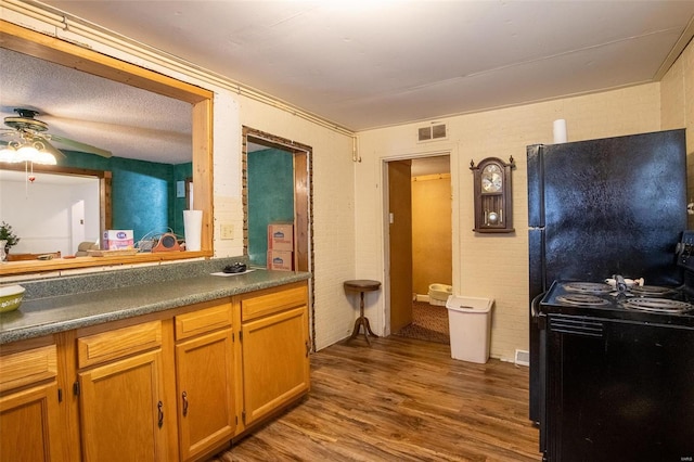 bathroom featuring a textured ceiling, hardwood / wood-style flooring, and ceiling fan