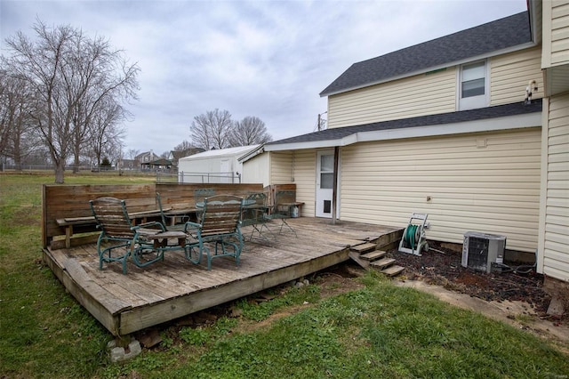 wooden terrace featuring central AC unit and a lawn