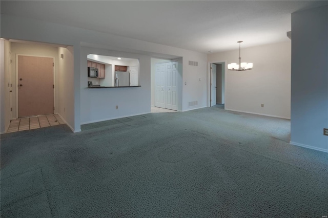 unfurnished living room featuring light carpet and a notable chandelier