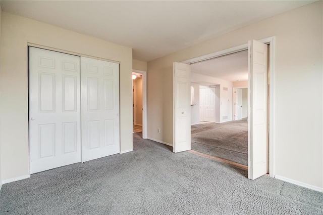 unfurnished bedroom with a closet and carpet floors