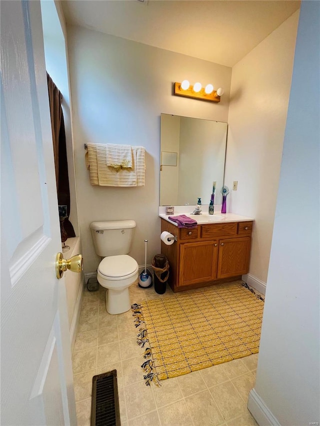 bathroom featuring tile patterned floors, vanity, and toilet