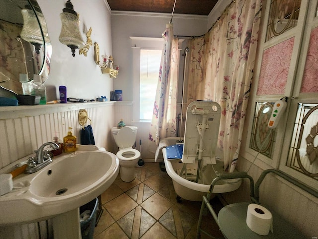 bathroom featuring crown molding, sink, and toilet