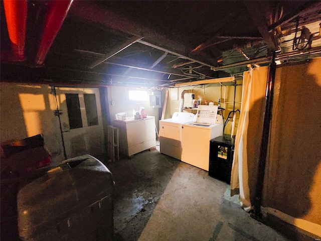 basement featuring separate washer and dryer and electric panel