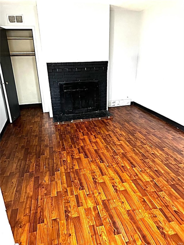 room details with a fireplace and wood-type flooring