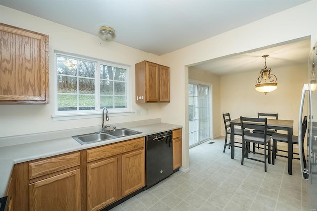 kitchen with sink, hanging light fixtures, and black dishwasher