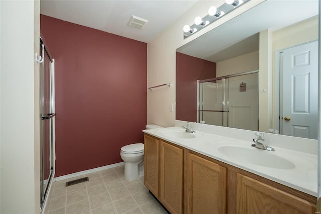 bathroom with vanity, toilet, and a shower with shower door