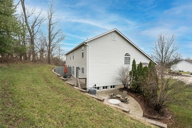 view of home's exterior featuring a lawn, central air condition unit, and a patio area