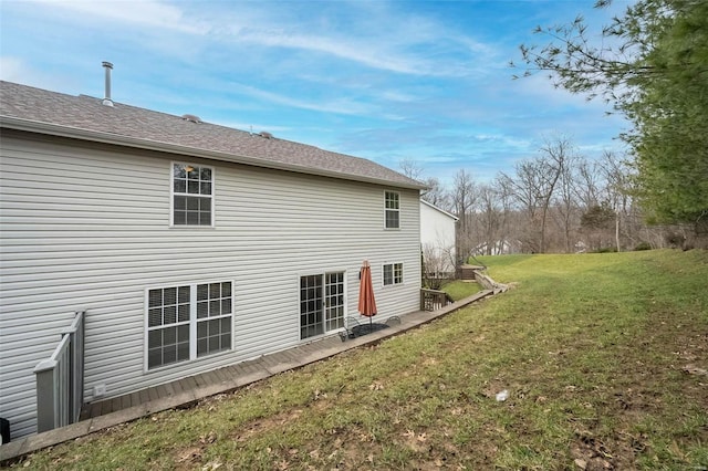 rear view of property with a yard