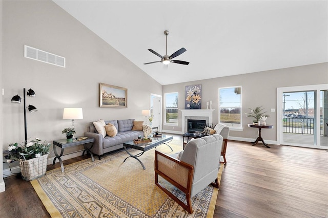 living room with hardwood / wood-style flooring, high vaulted ceiling, and ceiling fan