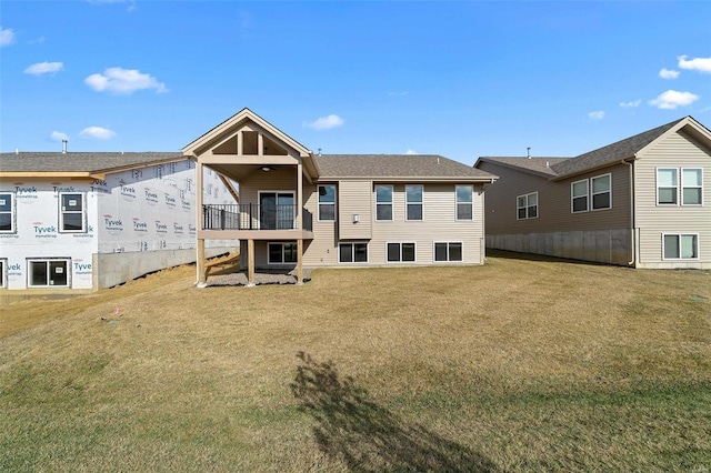 rear view of house featuring a yard