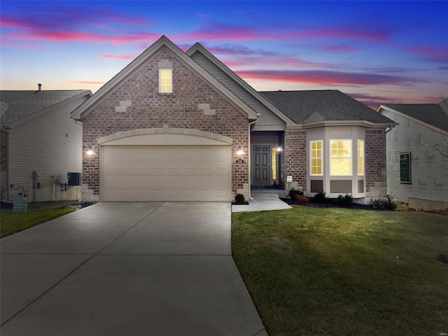 view of front of home featuring a garage and a lawn