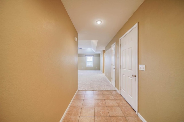 hall featuring light colored carpet