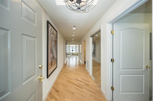 hallway with light hardwood / wood-style flooring