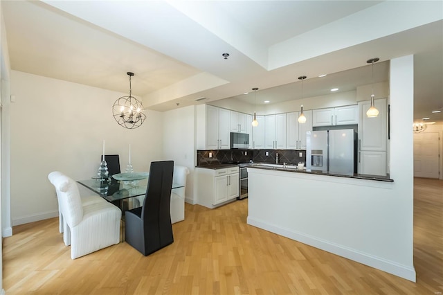 kitchen featuring white cabinets, backsplash, pendant lighting, and fridge with ice dispenser