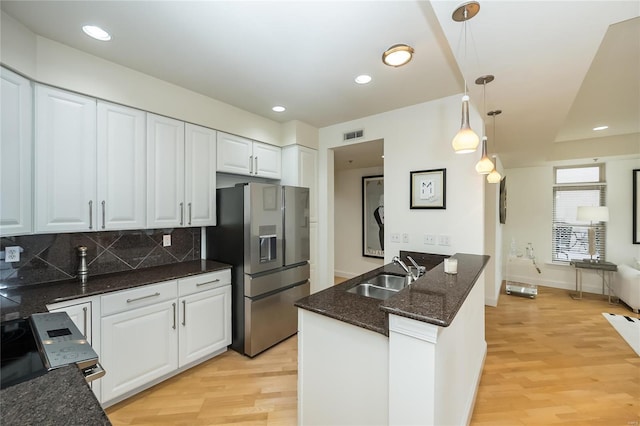 kitchen with decorative light fixtures, sink, white cabinets, and appliances with stainless steel finishes