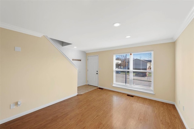 entryway featuring crown molding and light hardwood / wood-style floors