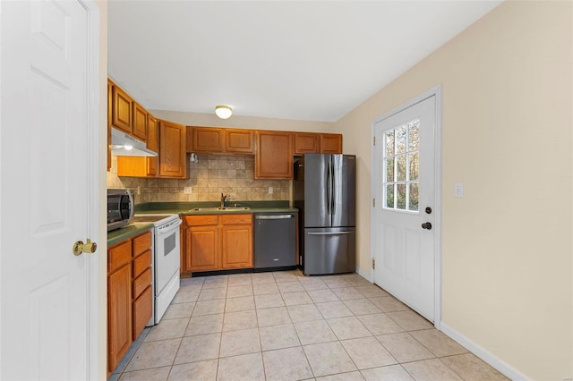 kitchen featuring backsplash, sink, light tile patterned floors, and stainless steel appliances