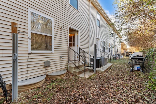 view of side of home featuring central AC unit