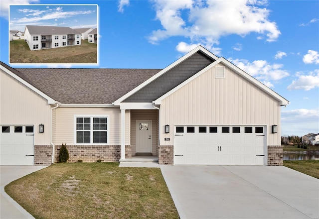 craftsman inspired home featuring a water view, a front lawn, and a garage